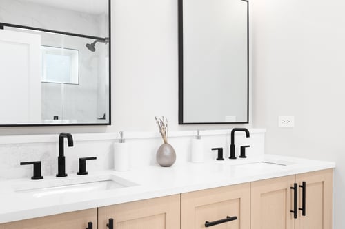 Modern double sink bathroom vanity with black fixtures in a Cape Cod, MA home by @designREMODEL