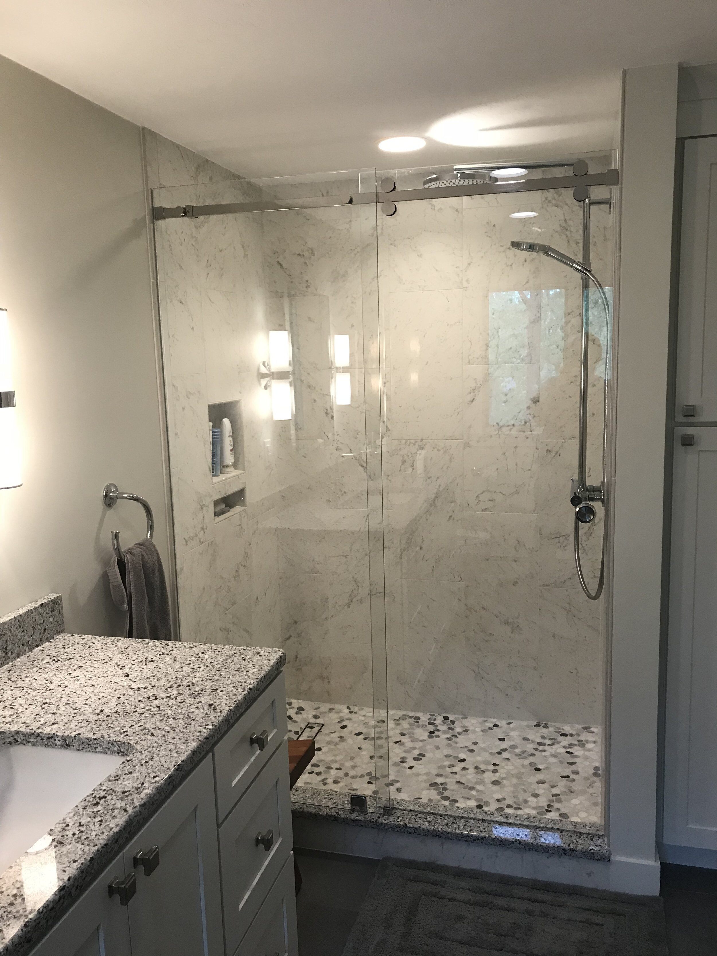 Frameless bypass door of bathroom remodel.