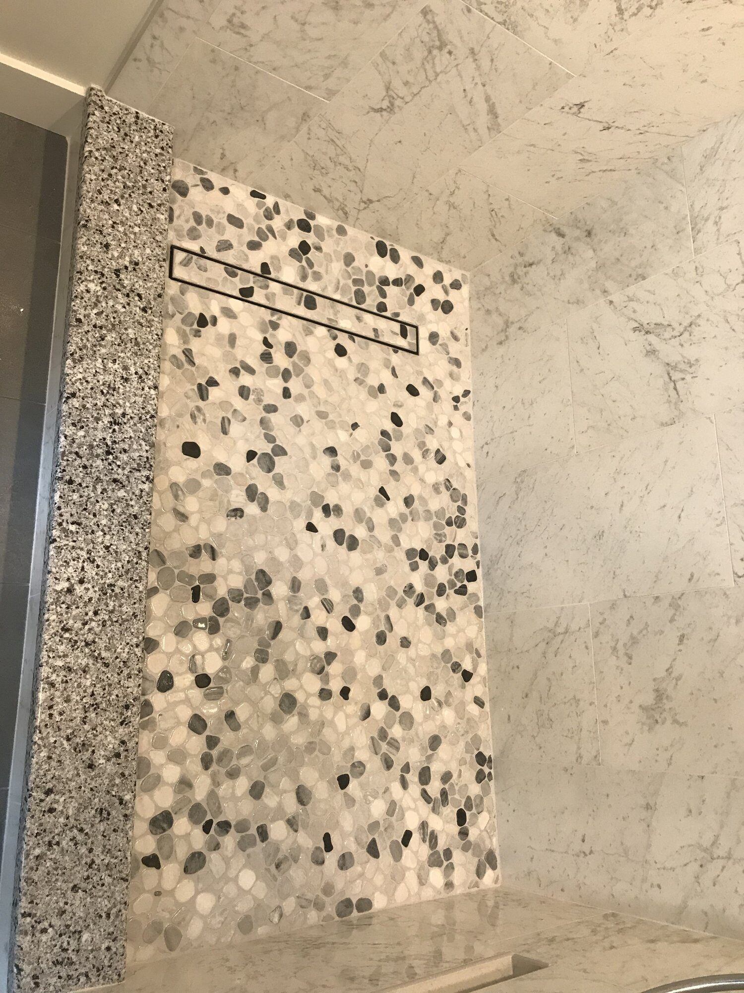 Overhead image of river rock floor in shower.