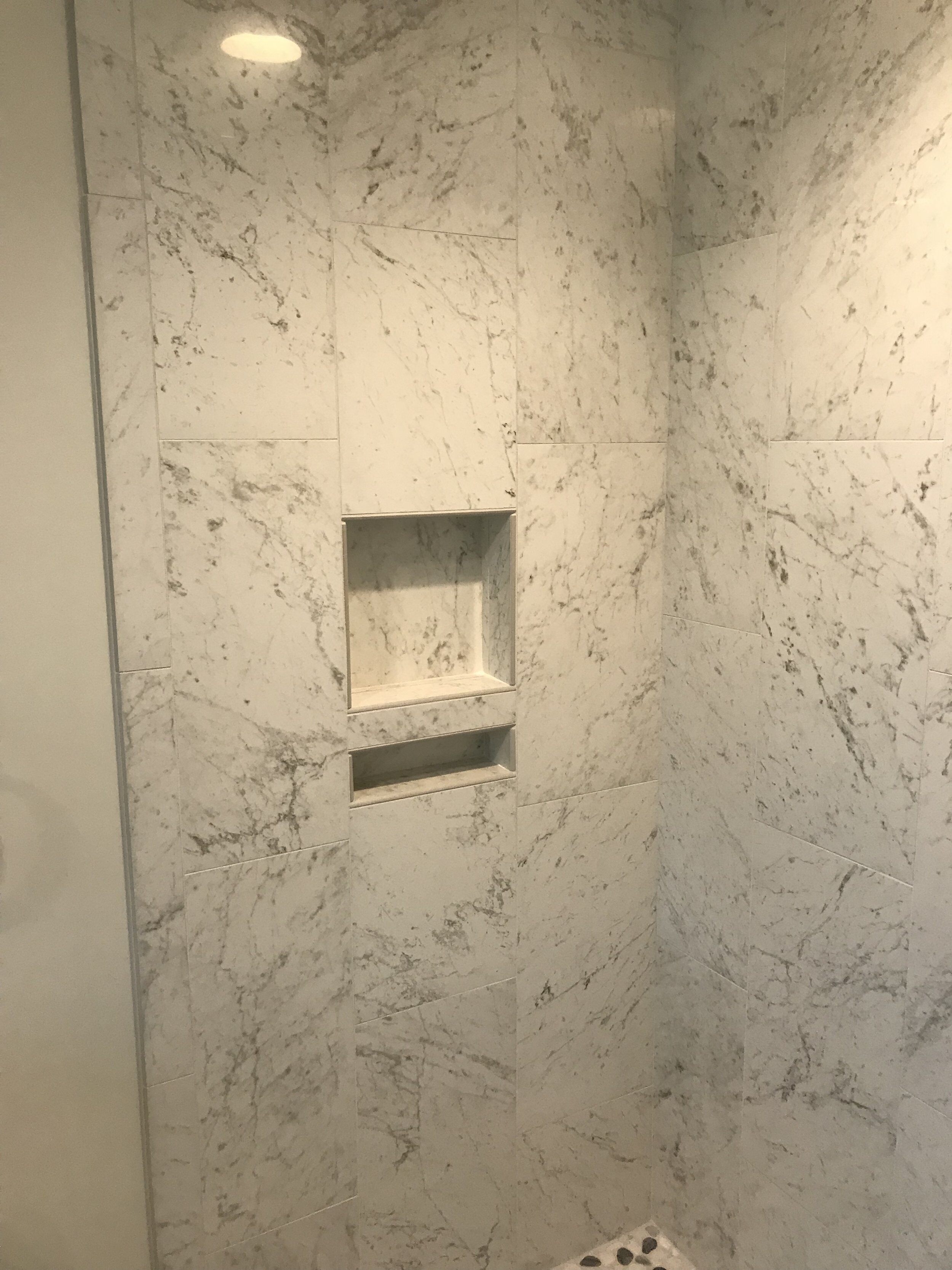 Spacious shower with custom built in niches.