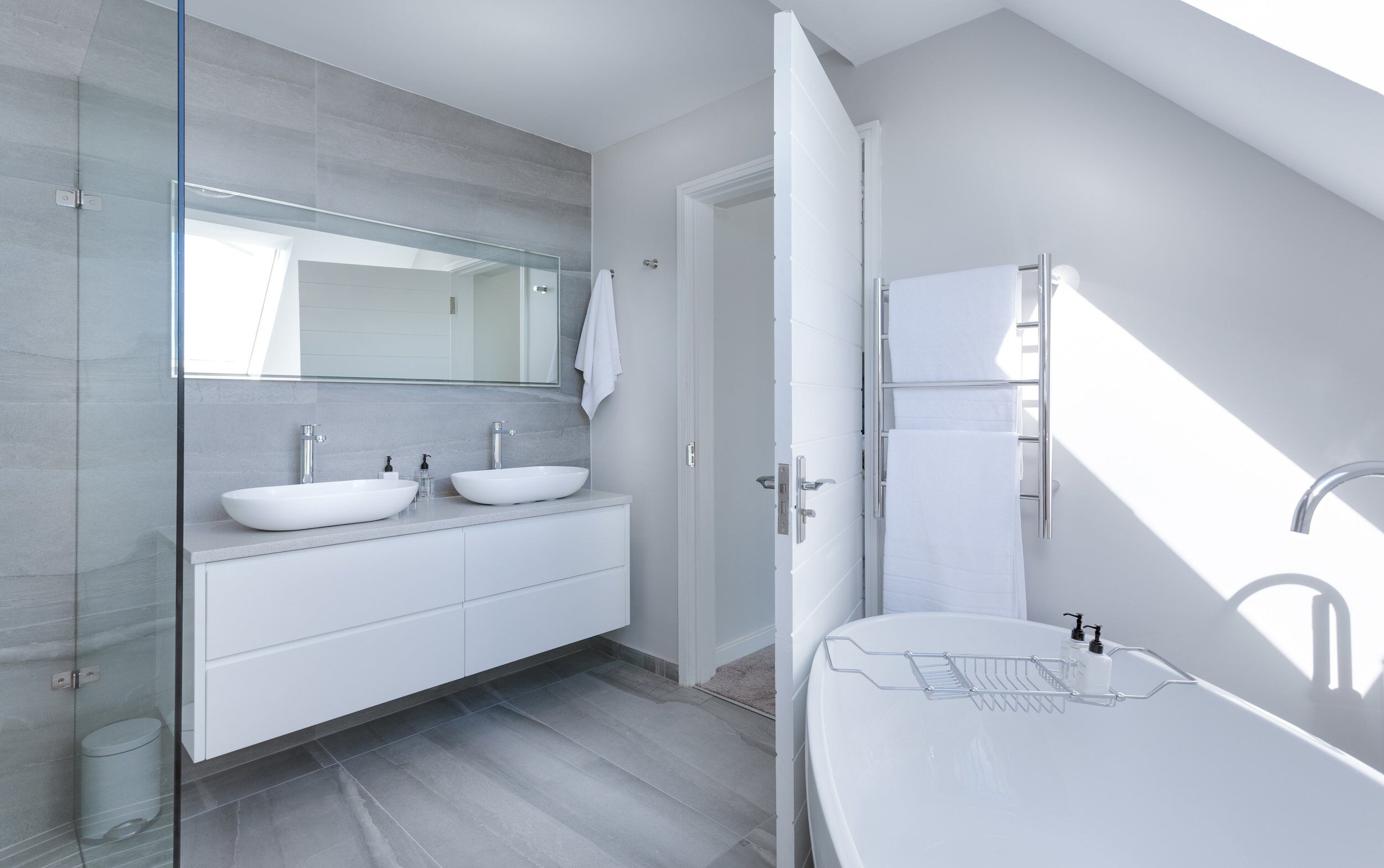 White contemporary bathroom sinks and tub.
