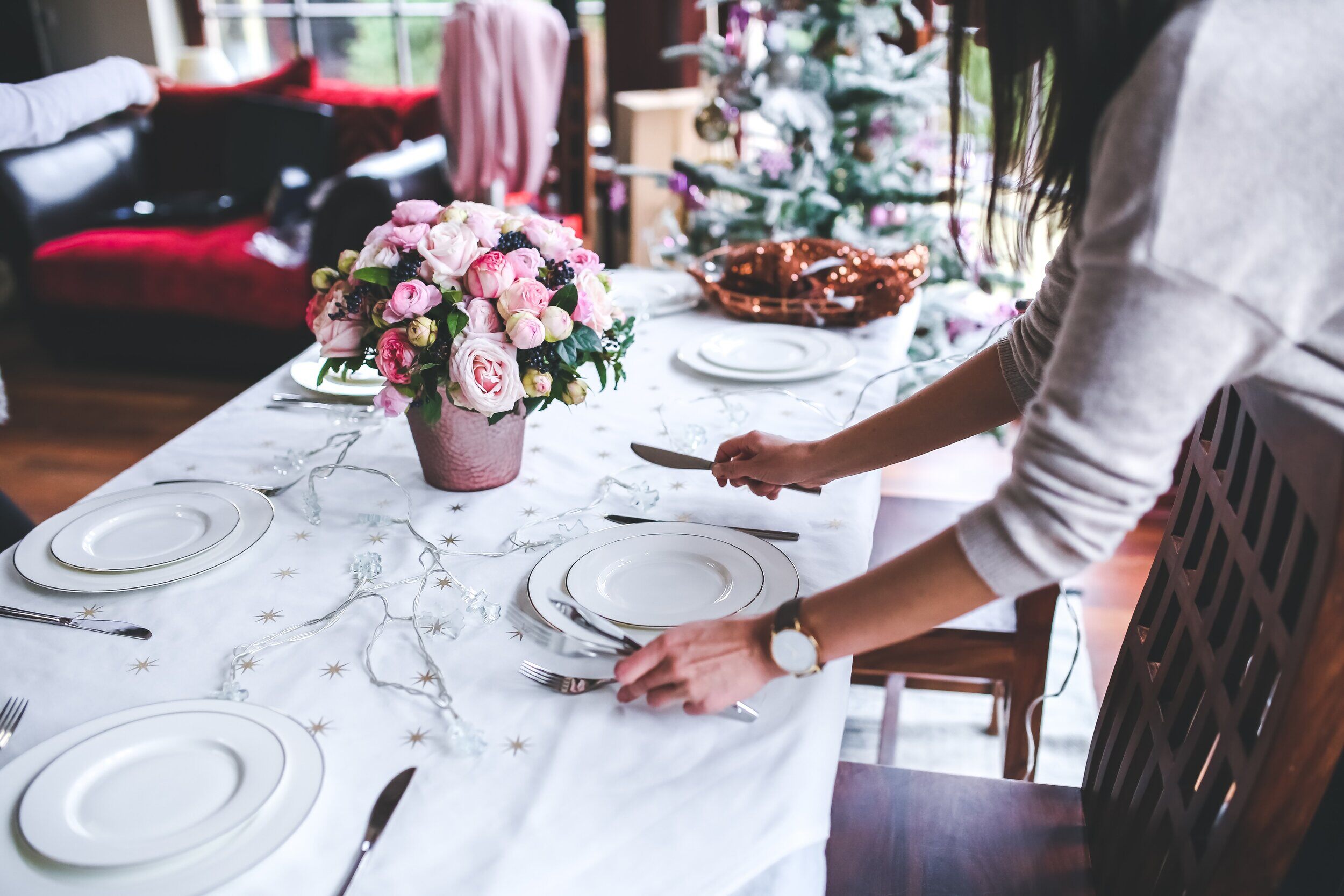 Woman preparing Christmas dining table