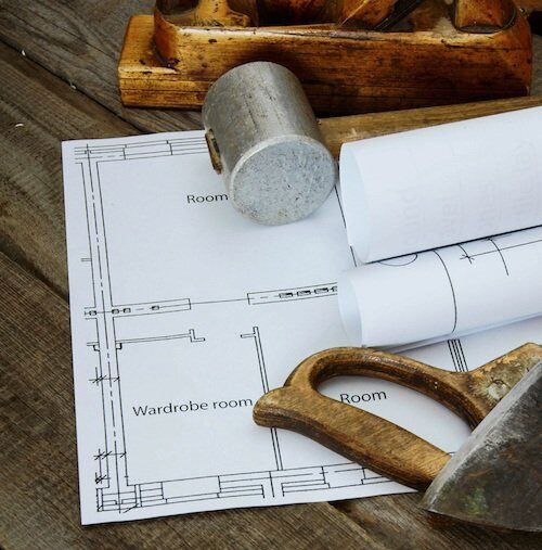 Blueprint for home remodel with tools.