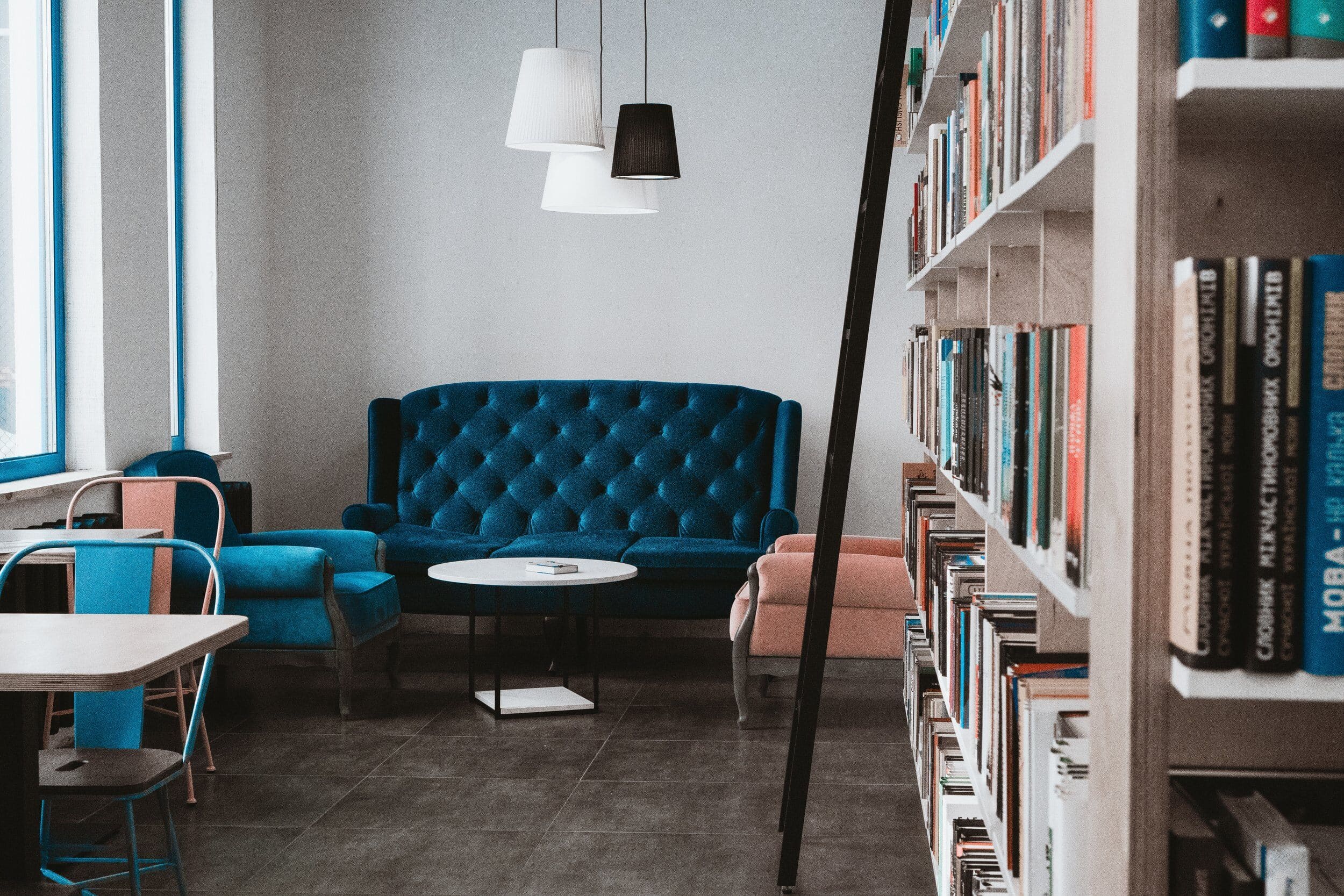 Deep blue couch and bookcase