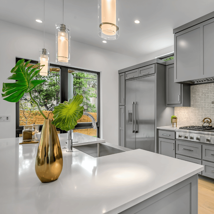 Kitchen with pendant lights over large center island