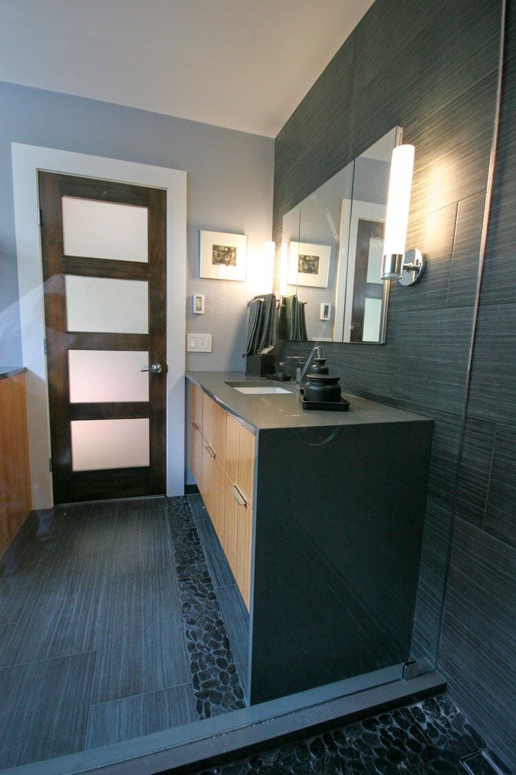 Luxurious dark-tiled bathroom remodel in Sandwich with wooden accents
