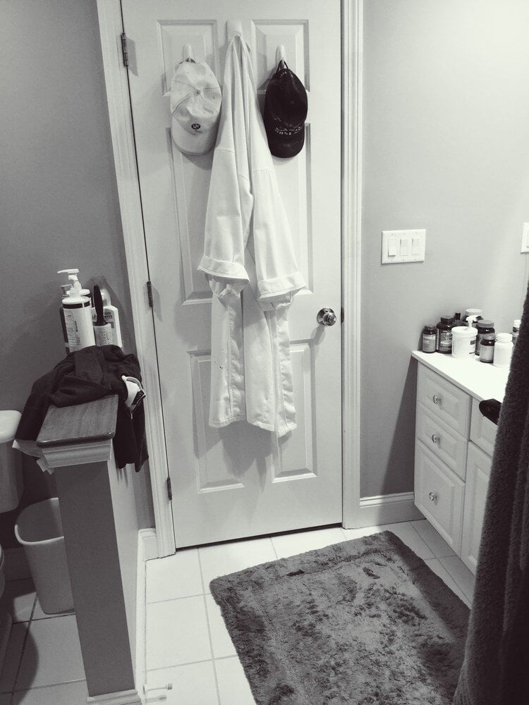 Simple Mashpee bathroom with hanging clothes and minimalistic decor