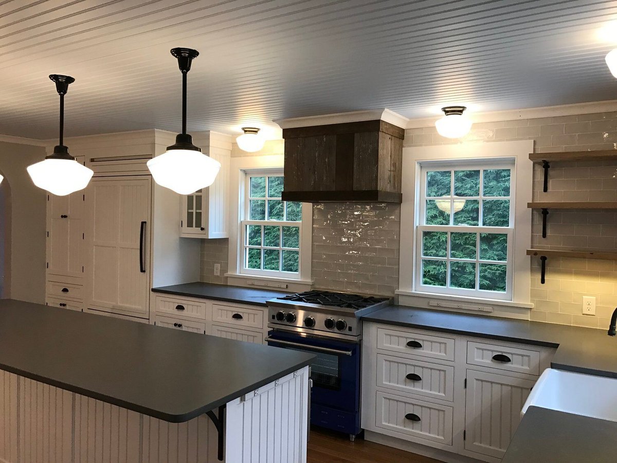 Spacious kitchen with white cabinetry and rustic wood accents in Falmouth, remodeled by At Design Remodel