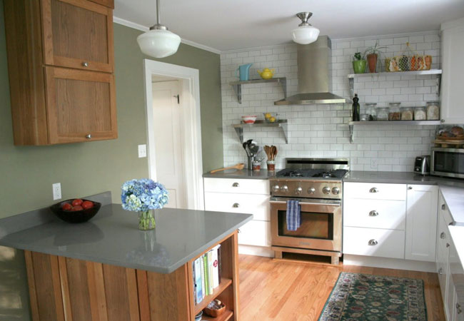 Traditional kitchen with green walls and wood accents in a Cape Cod home remodeled by @designREMODEL