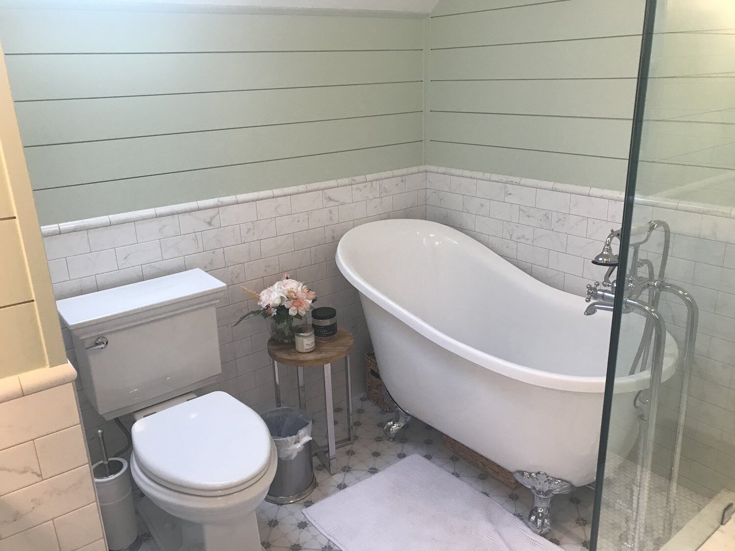 Spacious bathroom with freestanding clawfoot tub and glass shower in New Seabury remodel